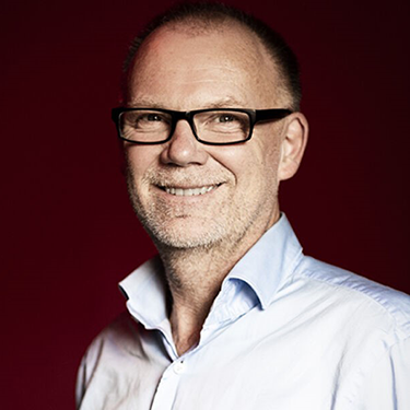 Anders Ynnerman smiling at the camera in front of a dark background.