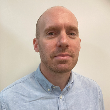 Björn Svensby Kurling in a blue shirt in front of a white background