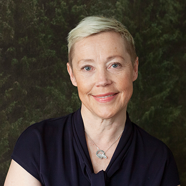 portrait photo of Ella Jonsson in front of a dark forest like background