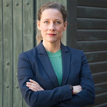 Lisen Schultz looking towards the camera with her arms crossed