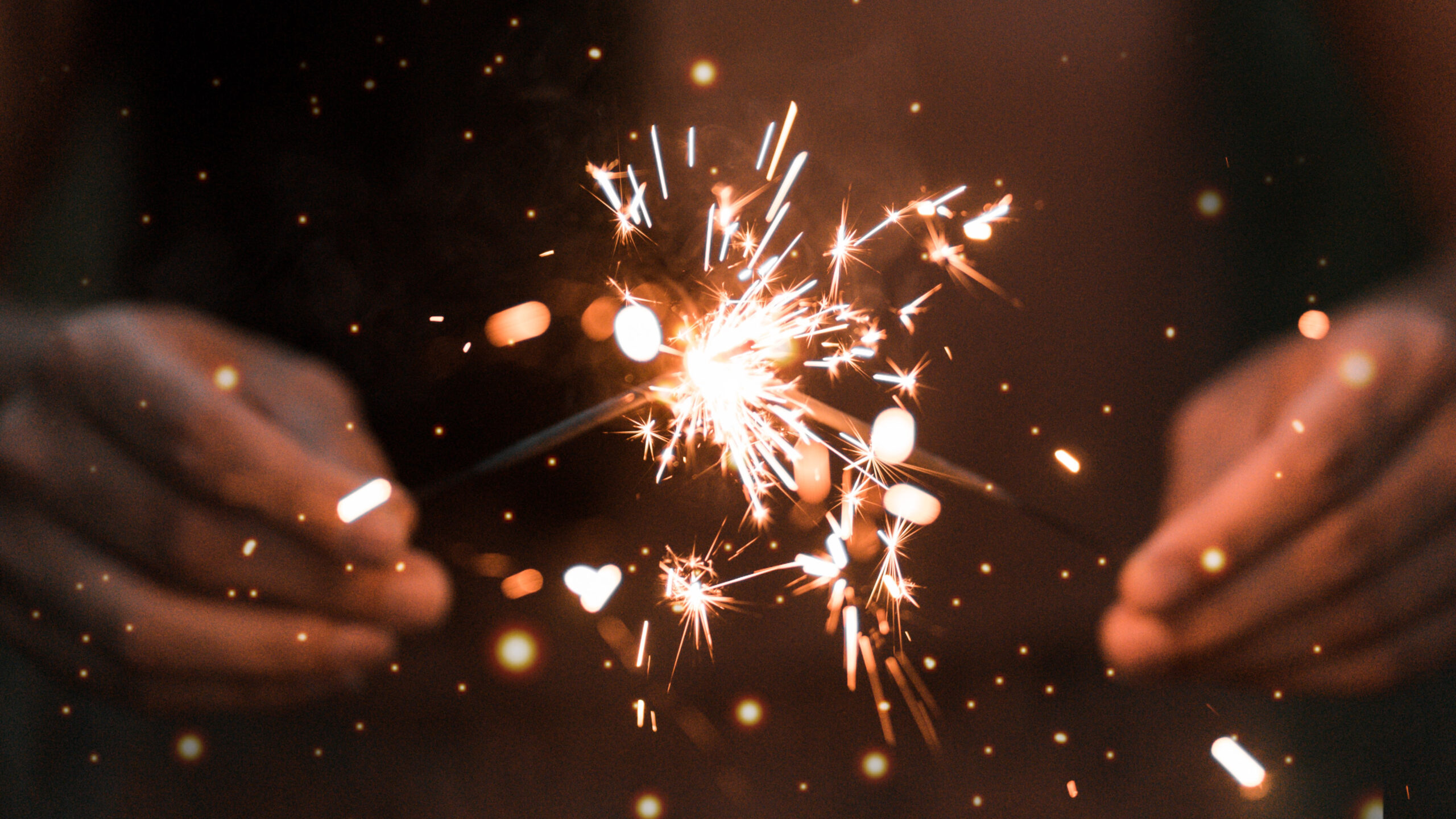 Hands holding a sparkler